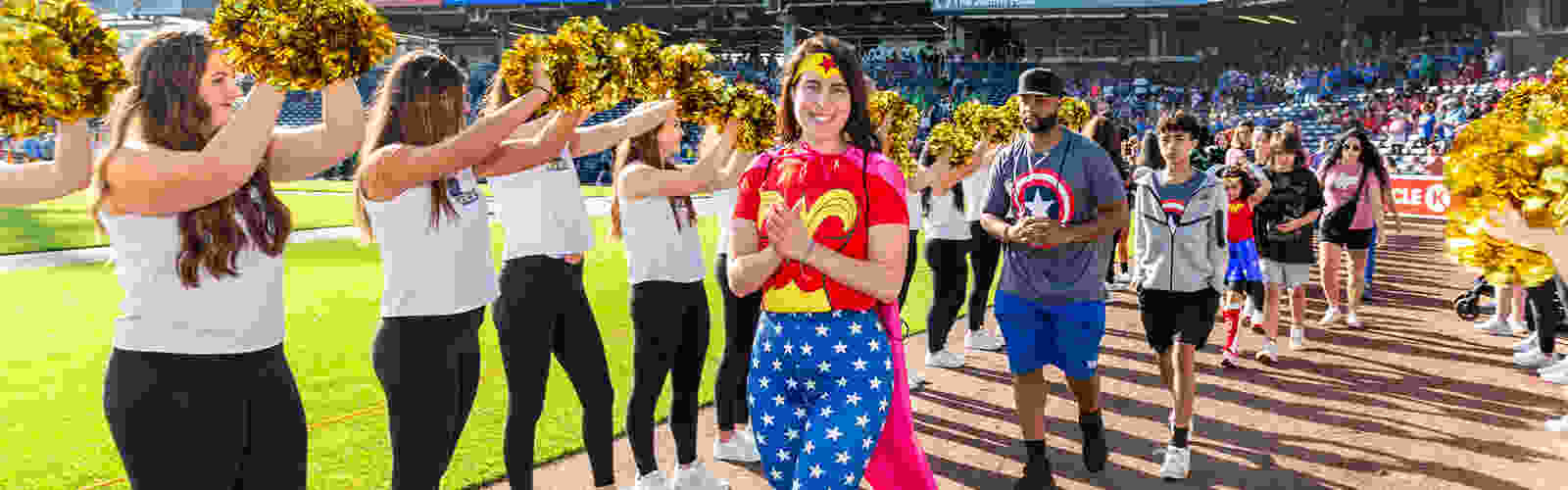 Cancer survivors taking part in the survivor lap on the warning track of Polar Park